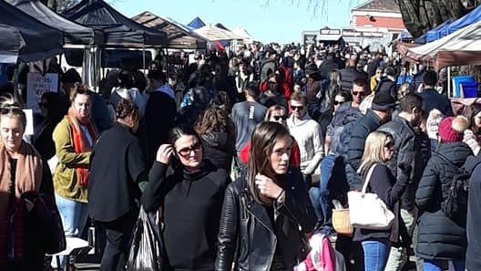A large crowd of people at a market.
