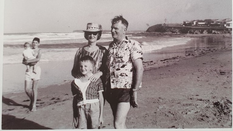 black and white photo of family at beach