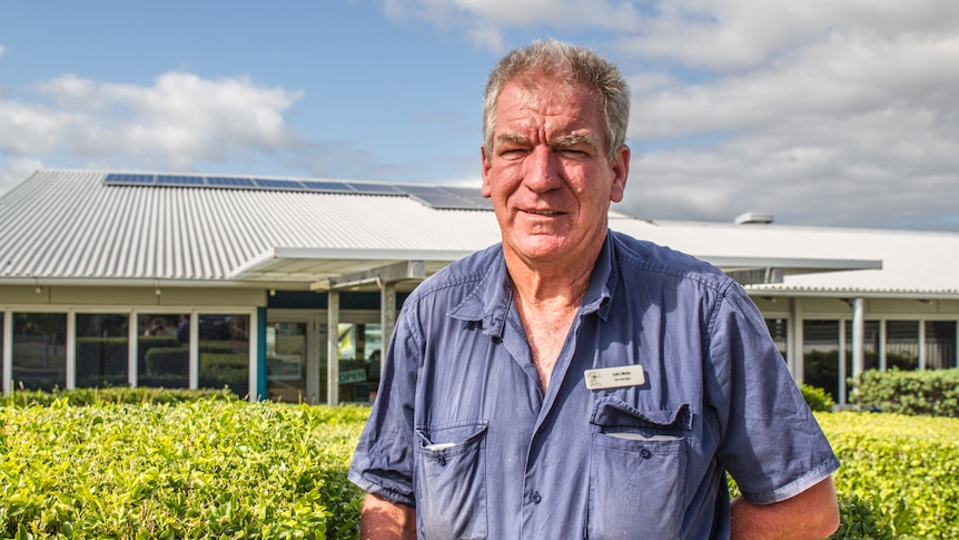 Len Moss standing with his well maintained hedges.