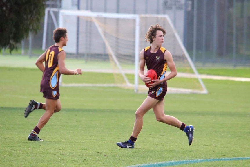 Tyler Brown playing football for Marcellin College.