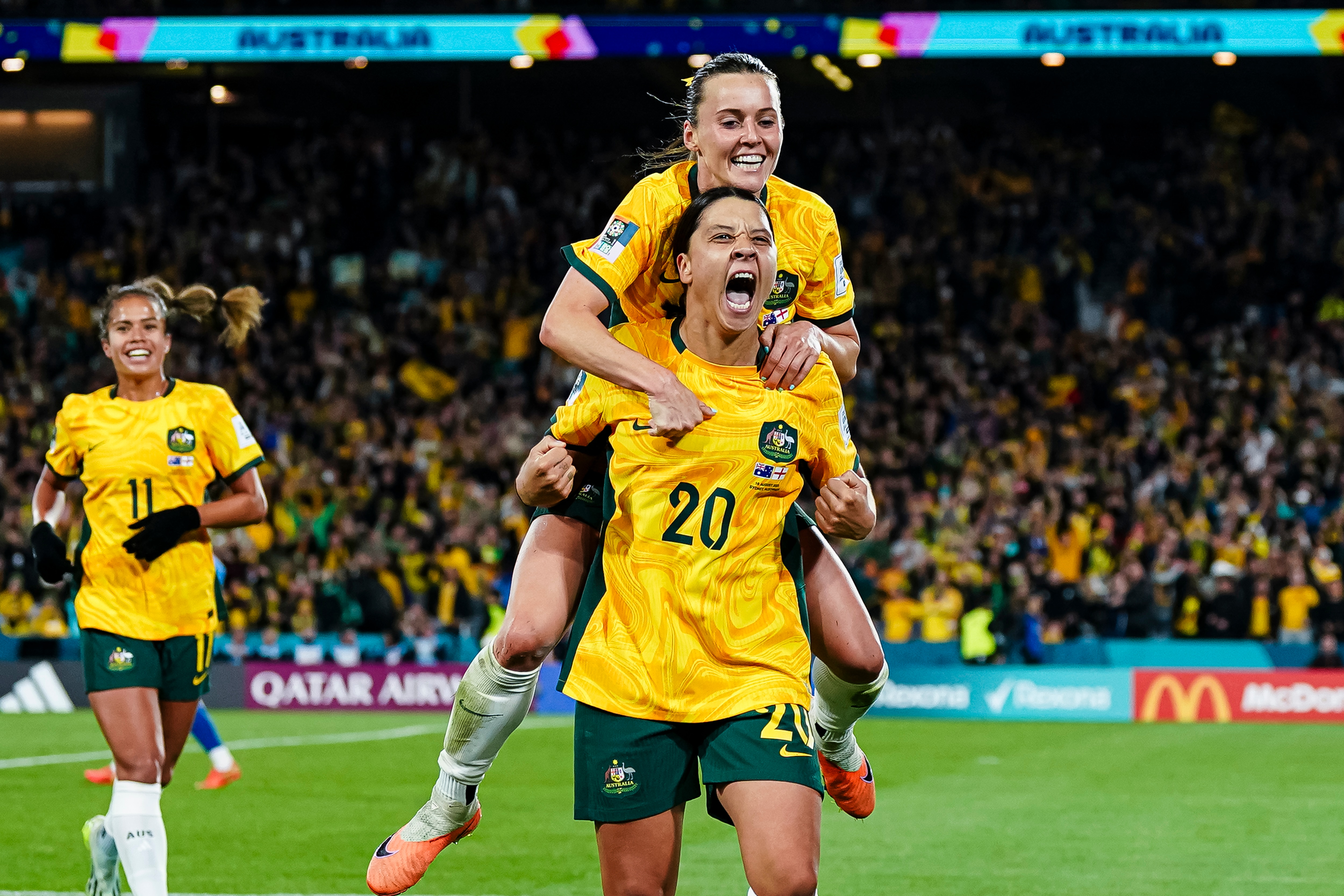 Two Matildas players celebrate a goal during the FIFA Women's World Cup.