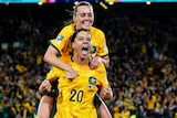 Two Matildas players celebrate a goal during the FIFA Women's World Cup.