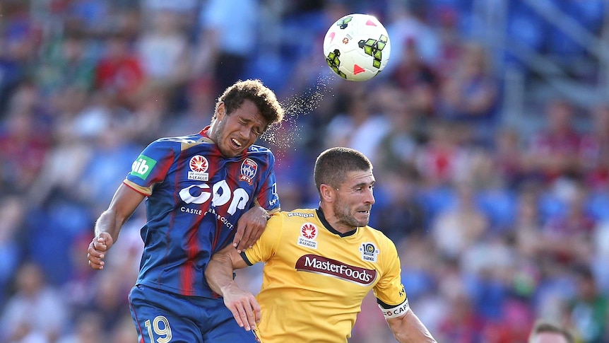 Nick Montgomery of the Mariners contests the header against Mitch Cooper of the Jets