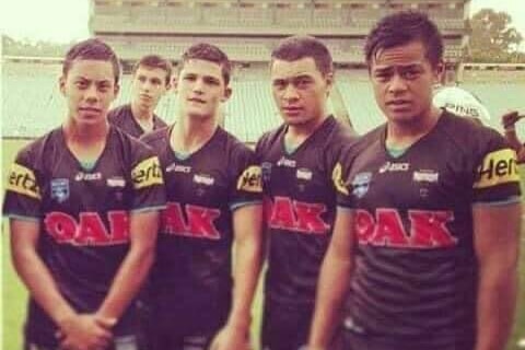 Four teenage boys in Penrith Panthers jerseys look at the camera.