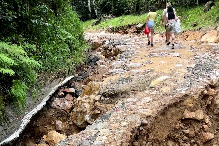 A road is torn apart by landslips.