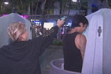 Man uses urinal on Cavill Mall at Surfers Paradise