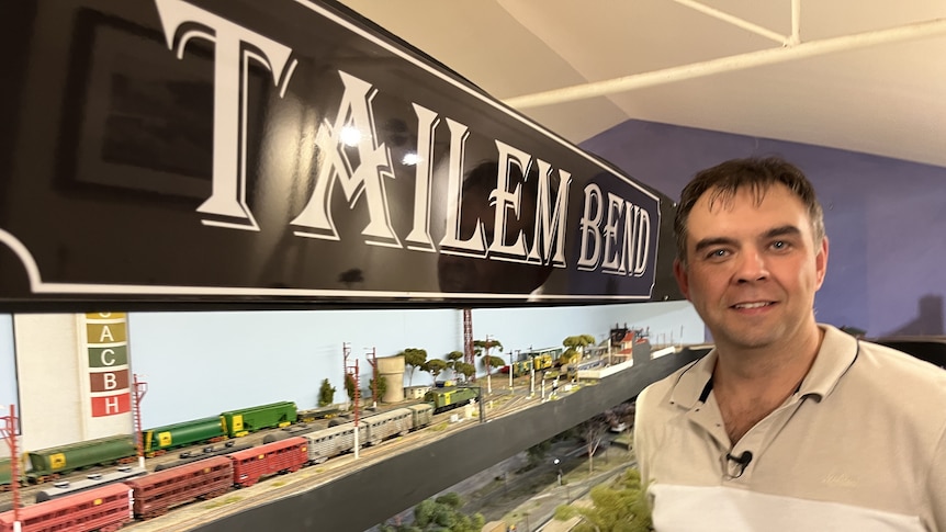 A man stands next to a model of the railway station at Tailem Bend