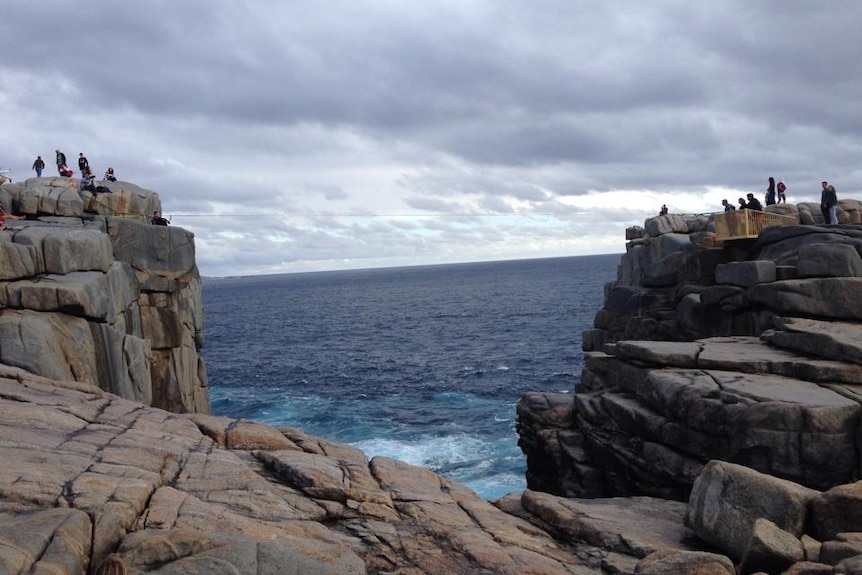 A rope stretches across choppy seas at The Gap in Albany.