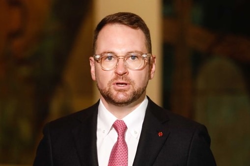 A man wearing a suit and glasses