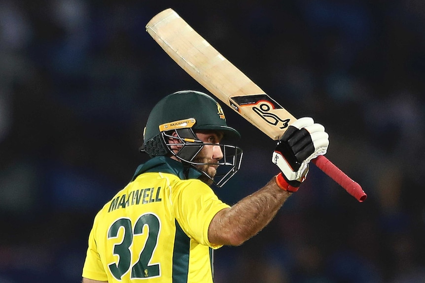 Glenn Maxwell holds his bat with his right hand above his head