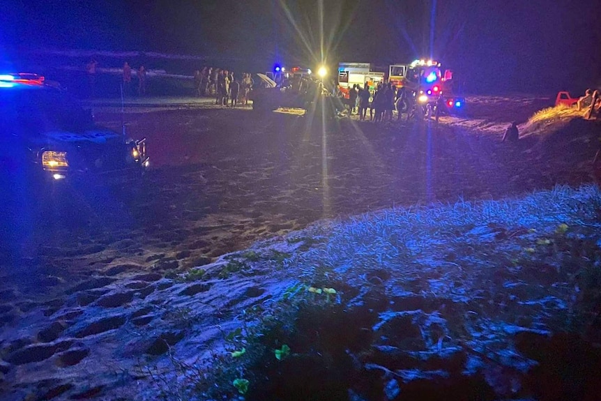 Emergency services at the scene of a four-wheel drive rollover on Teewah Beach that hospitalised two teenagers.