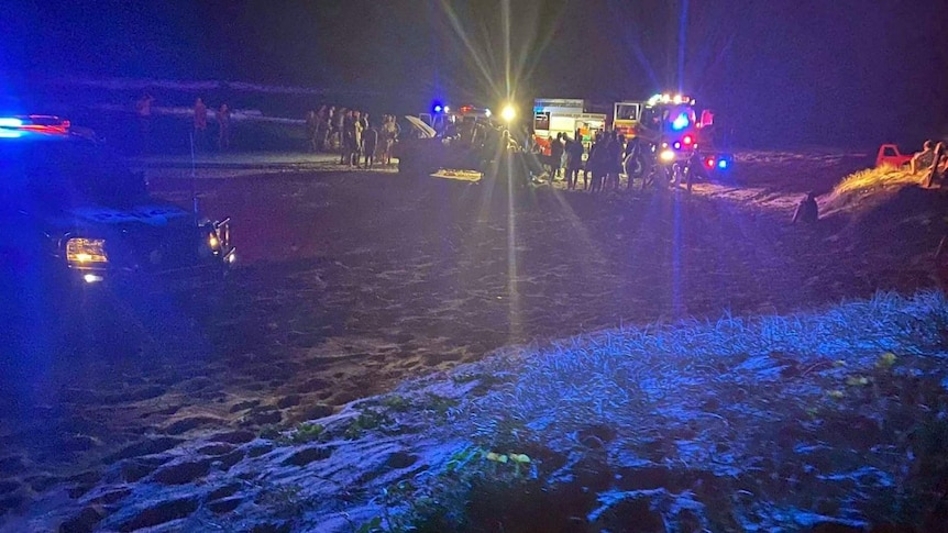 Emergency services at the cene of a four-wheel rollover on Teewah Beach about 7pm last Saturday that hospitalised two teenagers.