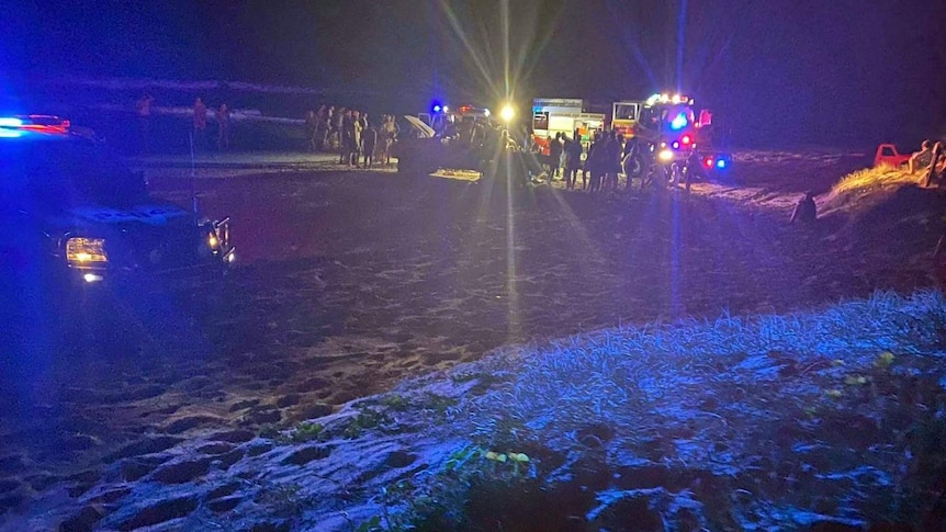 Emergency services at the scene of a four-wheel drive rollover on Teewah Beach that hospitalised two teenagers.