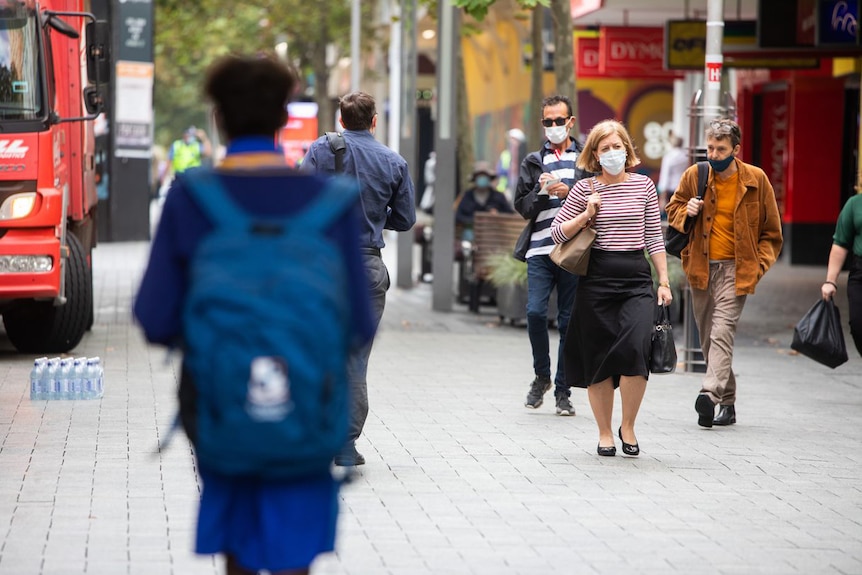 People in Perth's Hay Street mall walking along wearing masks.