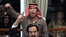 Saddam Hussein and his half-brother Barzan al-Tikriti berate the court during their trial in Baghdad.