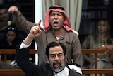 Saddam Hussein and his half-brother Barzan al-Tikriti berate the court during their trial in Baghdad.