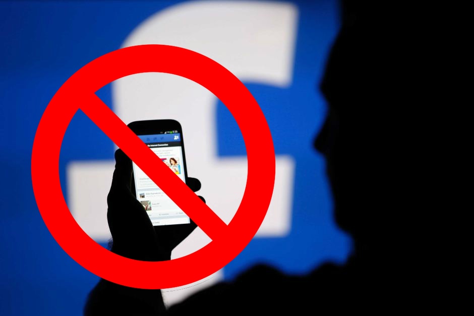 Man using Facebook with a ban symbol