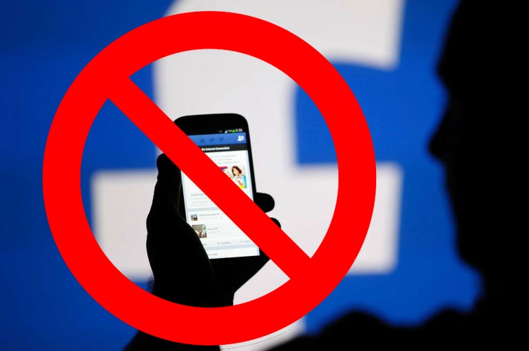 Man using Facebook with a ban symbol