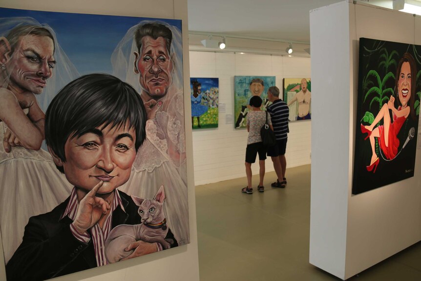 Art admirers check out the Bald Archy finalists alongside Judy Nadin’s Two Rights Don’t Make A Wong.