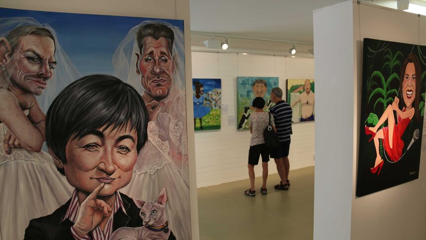 Art admirers check out the Bald Archy finalists alongside Judy Nadin’s Two Rights Don’t Make A Wong.