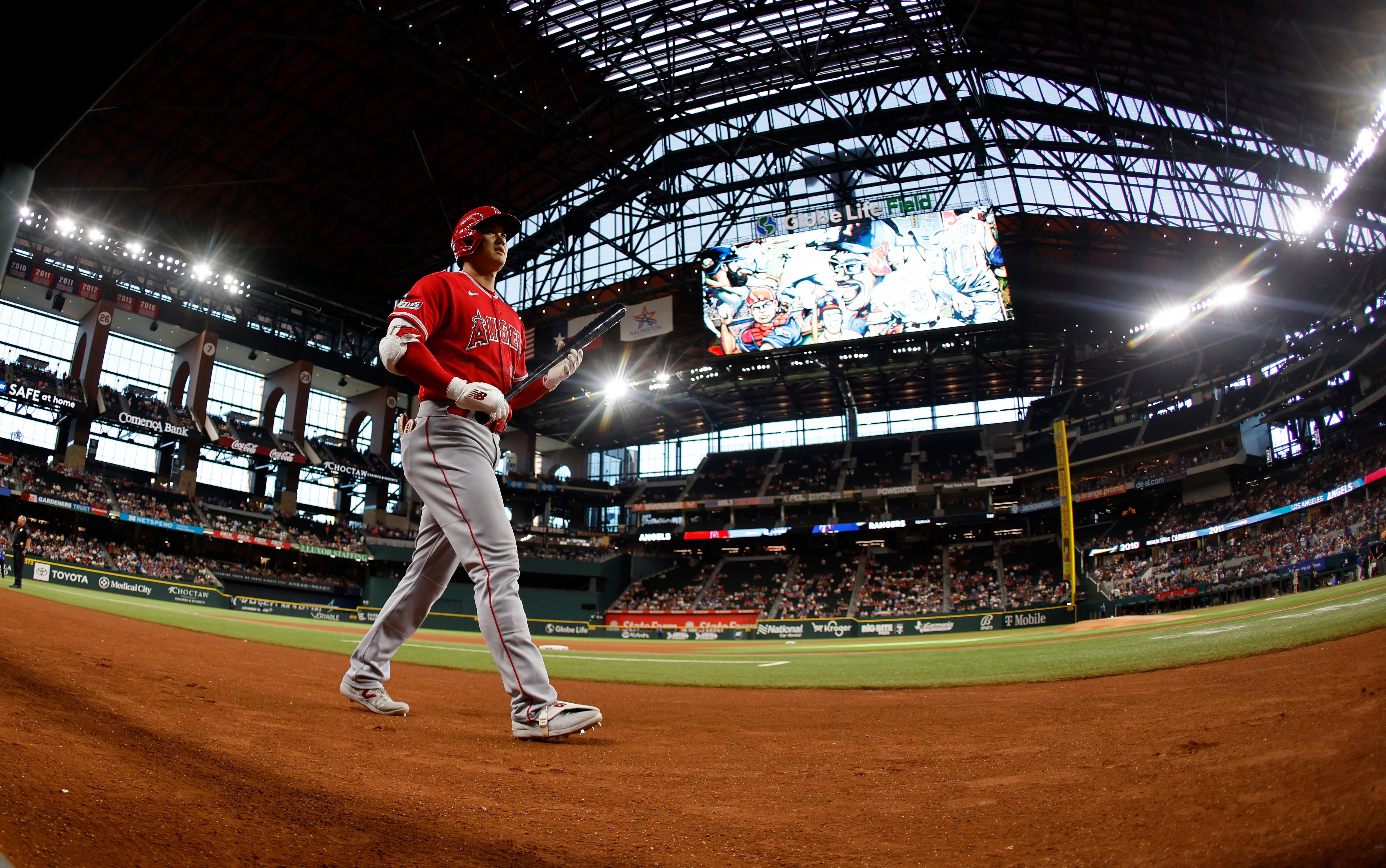 A man walks to the batters box during a baseball game