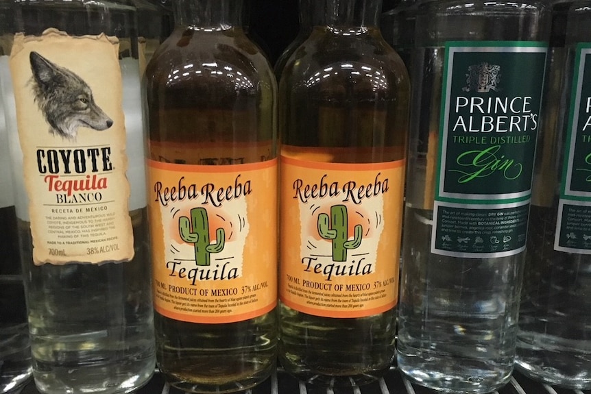 Four bottles of Tequila on a shelf at a bottle shop.