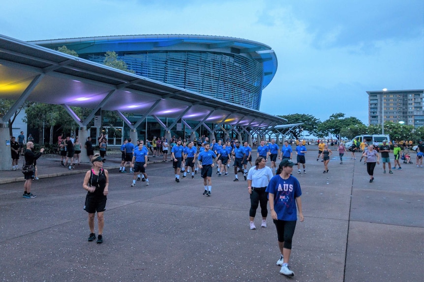 People outside a large modern building.