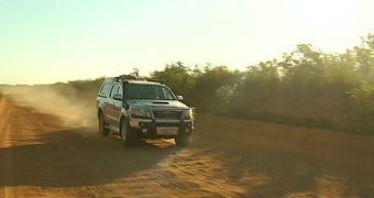 A car driving along a dirt road