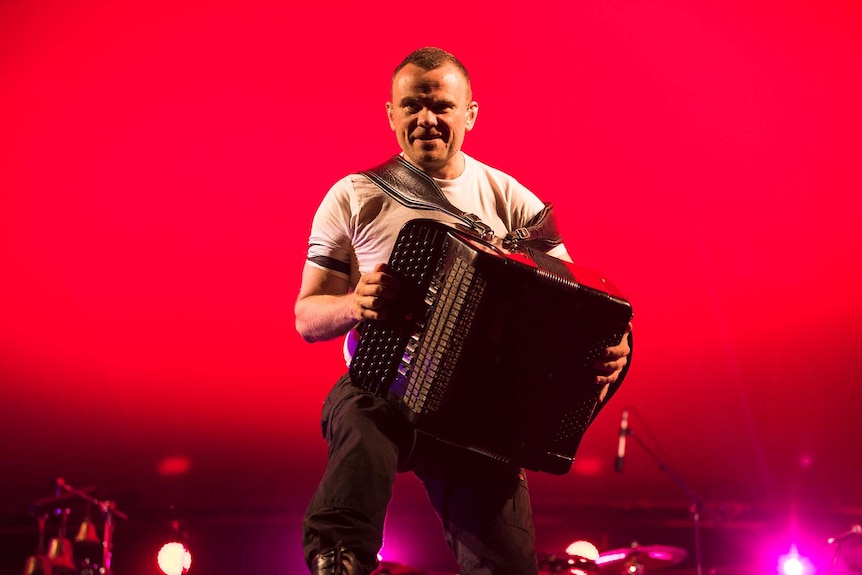 An accordion player from gypsy punk band Gogol Bordello snarls at the crowd.