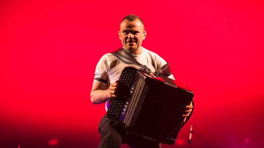 An accordion player from gypsy punk band Gogol Bordello snarls at the crowd.