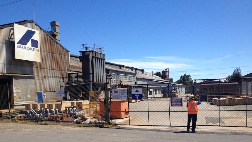 A worker shuts the gates at the Bradken foundry at Youungtown in Tasmania's north.