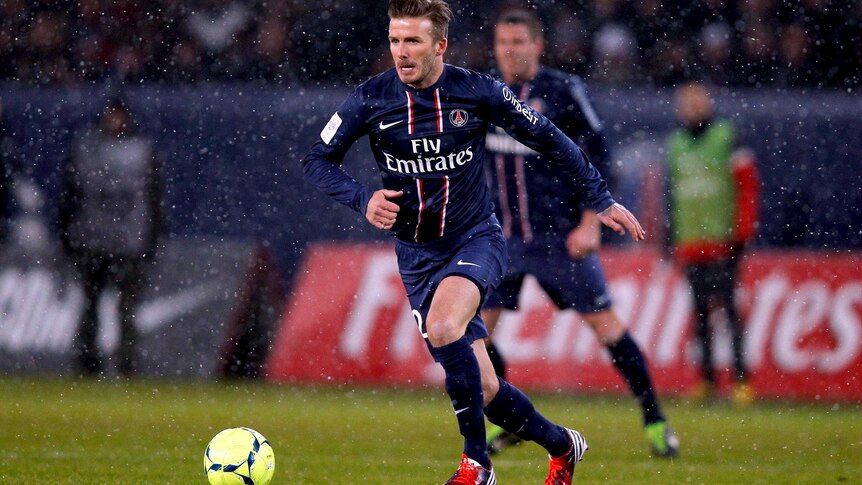 David Beckham moves with the ball during his PSG debut.