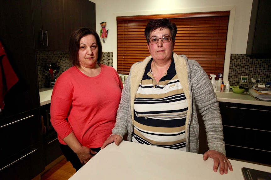 Sisters Lina and Rosa Fato stand side-by-side at a kitchen counter.