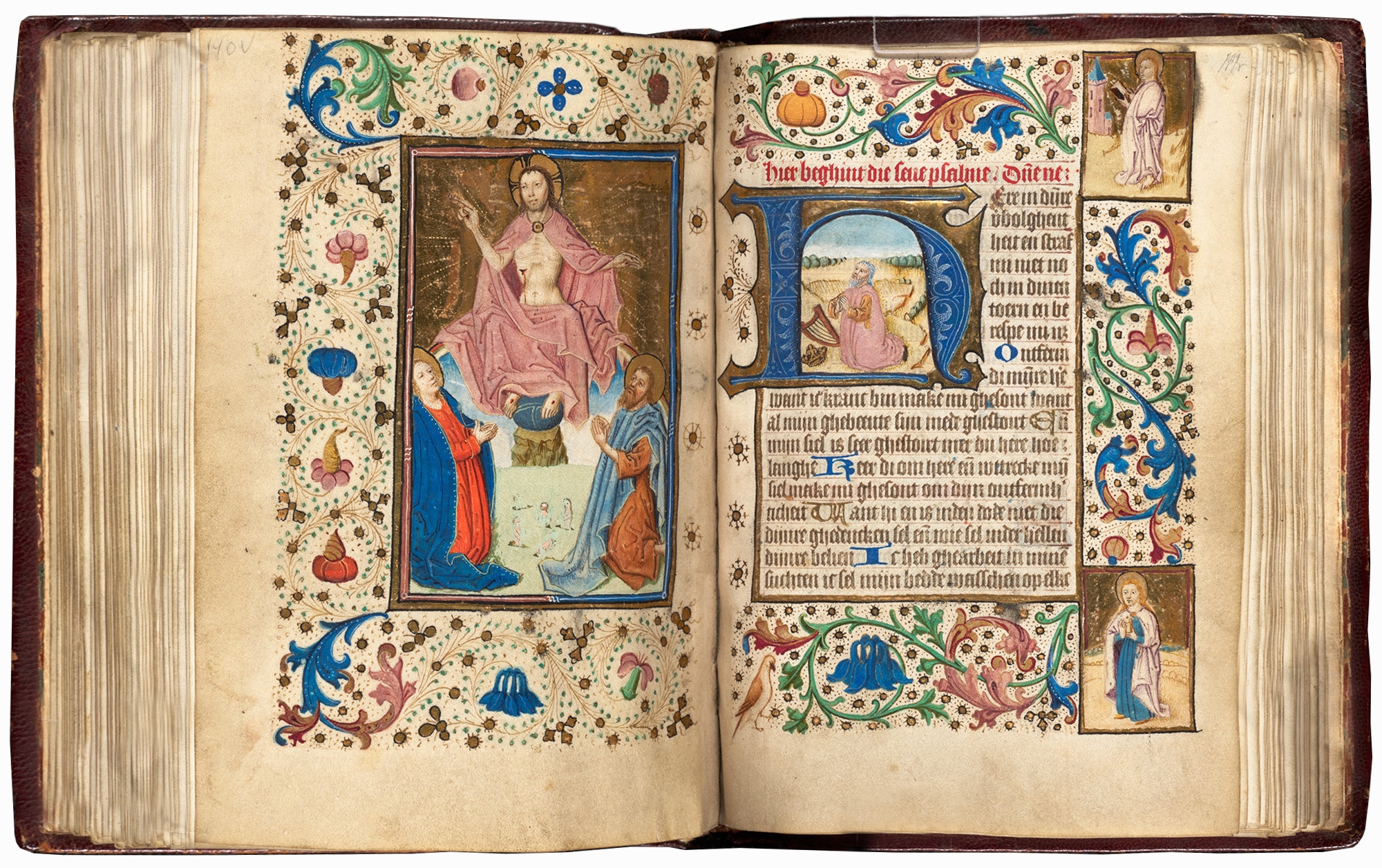 An open book with intricately decorated pages depicting Christian allegories.