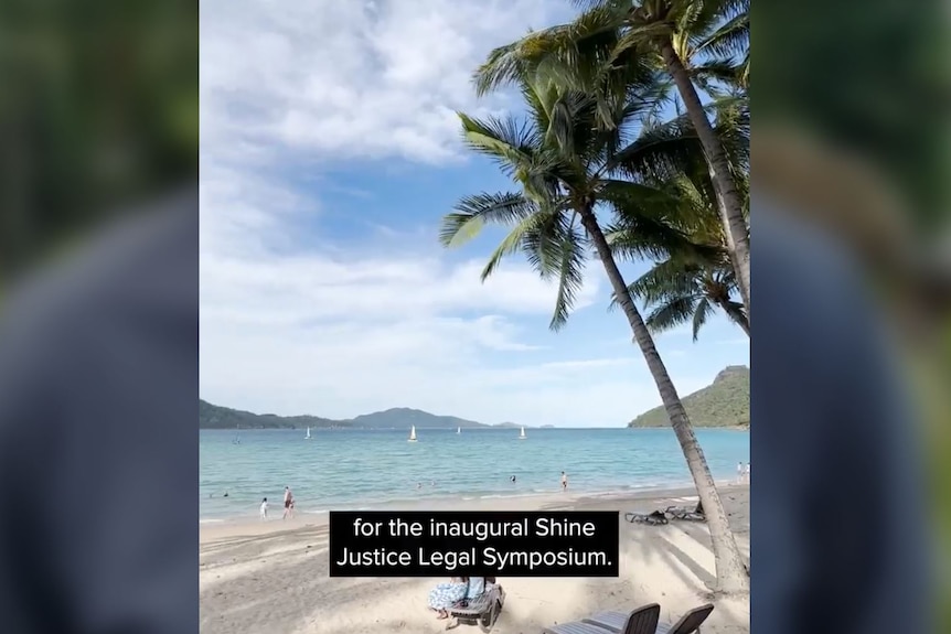 A screenshot of a video of a beach, with the words 'for the inaugural Shine Justice Legal Symposium' as a caption.