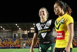 Emma Tonegato in a New Zealand jersey embraces Page McGregor, in a Jillaroos jersey, after their World Cup match.