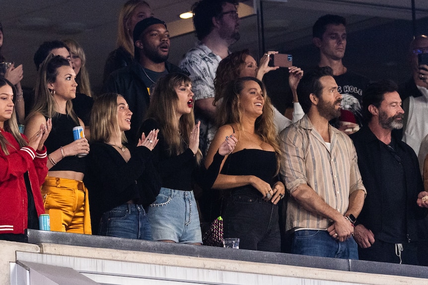 Taylor Swift, Blake Lively, Ryan Reynolds, Hugh Jackman stand and watch football