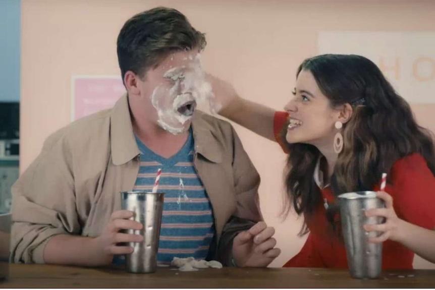 Still from the new government sexual consent campaign where a women is smearing milkshake cream on mans face