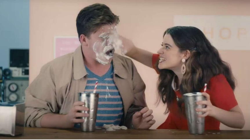 Still from the new government sexual consent campaign where a women is smearing milkshake cream on mans face