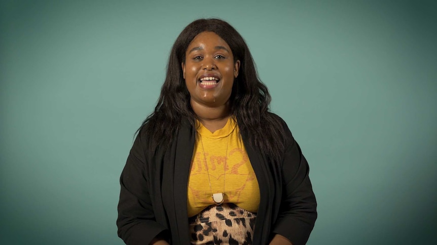 Aminatou Sow is sitting in front of a green screen and smiling