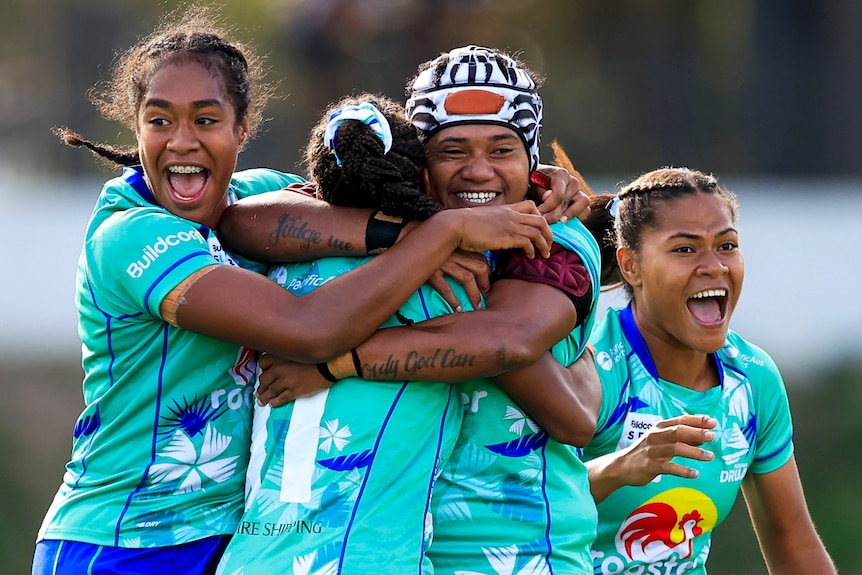 Four Fijiana Drua players celebrate beating the NSW Waratahs in the Super W semifinals.