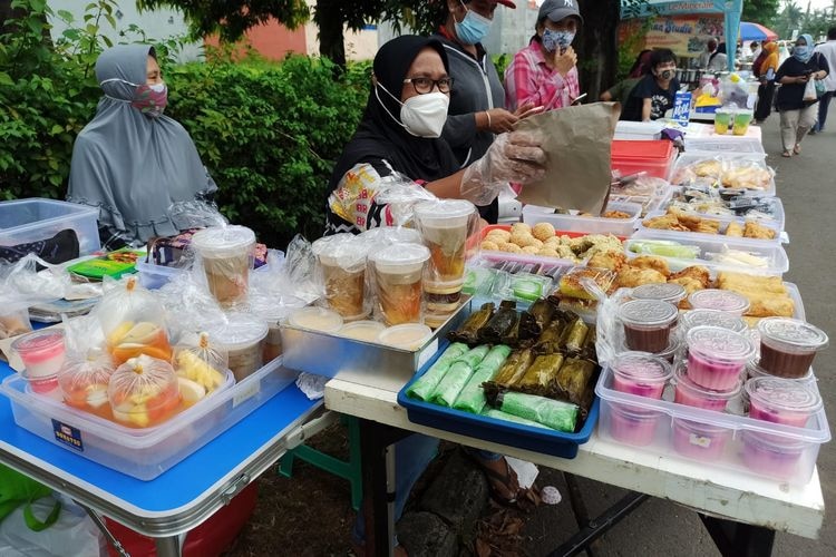 Women in hijab selling Indonesian traditional snacks or food.