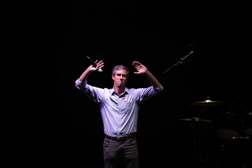 Beto O'Rourke waves to a crowd after conceding his race.