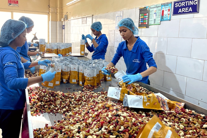 women sorting nuts and dried fruit
