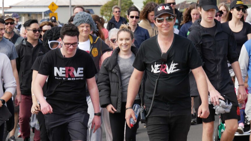 Cory Crombie and his dad walk 5km surrounded by hundreds of supporters