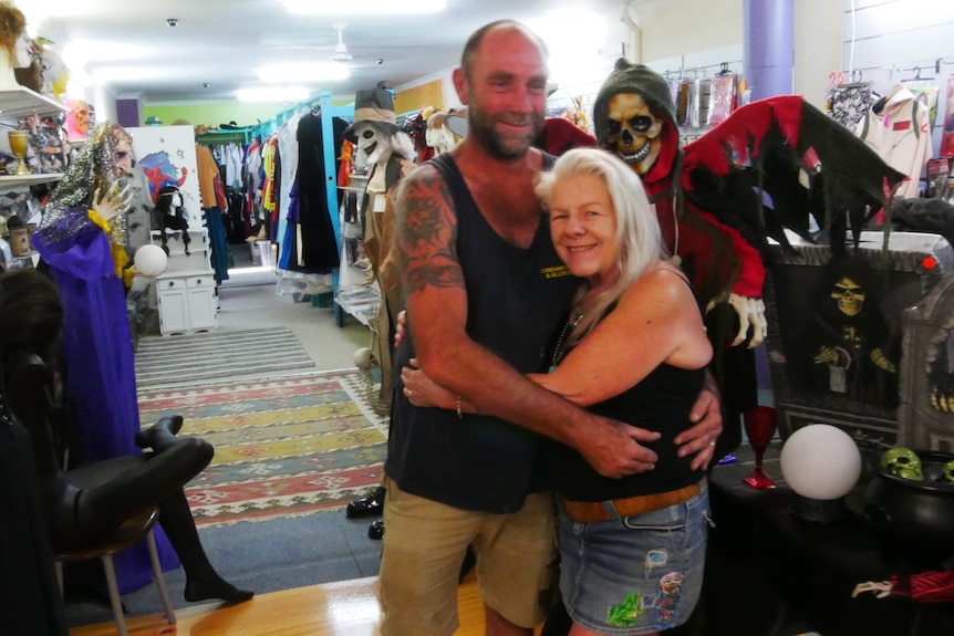 Couple hug in a costume store. 