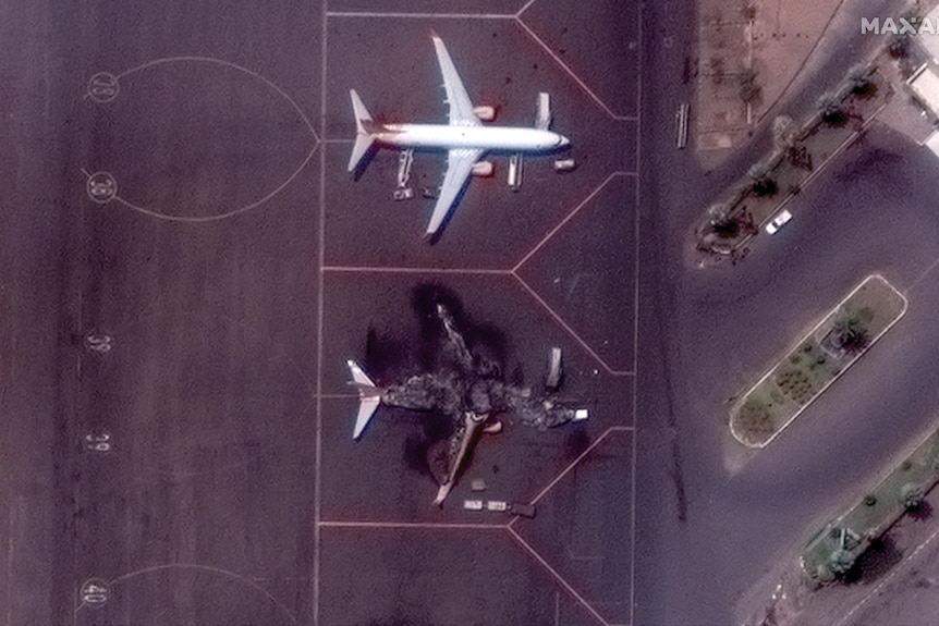 This satellite image provided by Maxar Technologies shows a destroyed Ukrainian airplane in Khartoum International Airport.