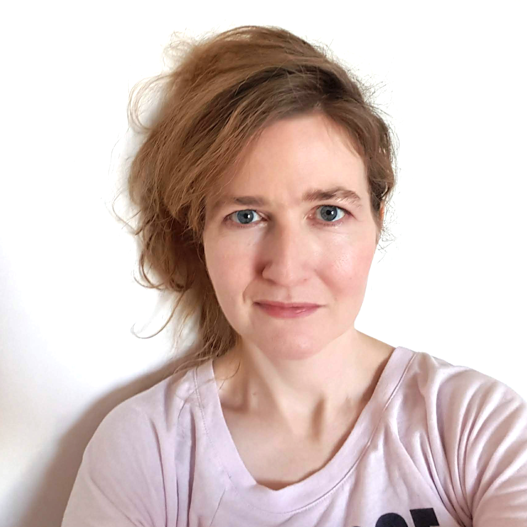 Photograph of games developer Katharine Neil standing in front of white wall.