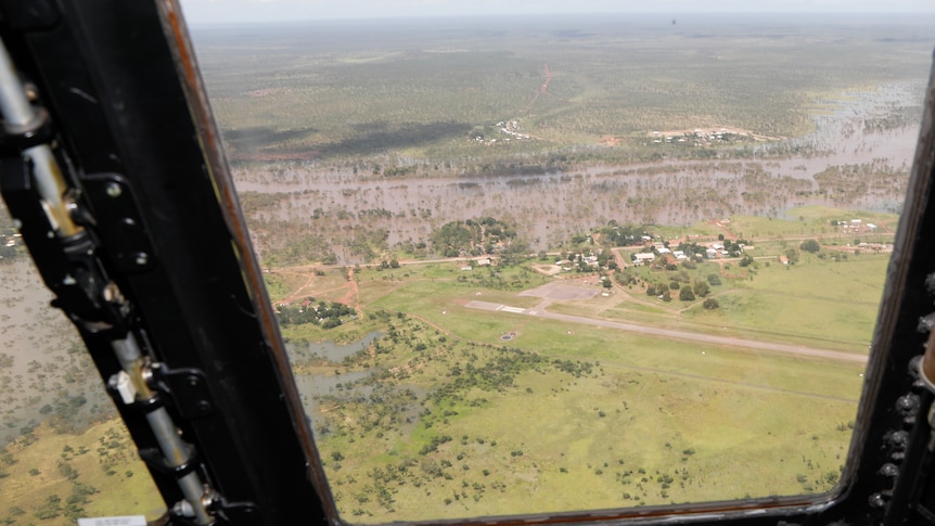 Flooding in Borroloola on Wednesday afternoon seen through the window of an ADF Spartan aircraft.