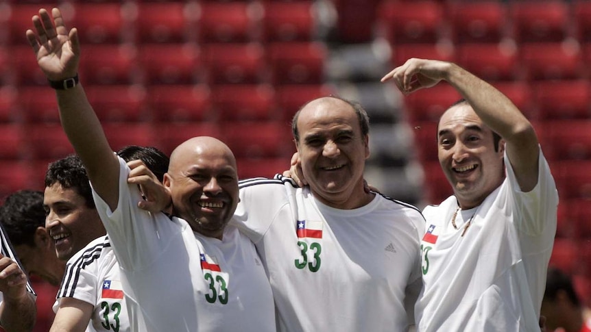 Rescued miners (left to right) Jose Ojeda, Franklin Lobos and Carlos Barrios celebrate during the match.